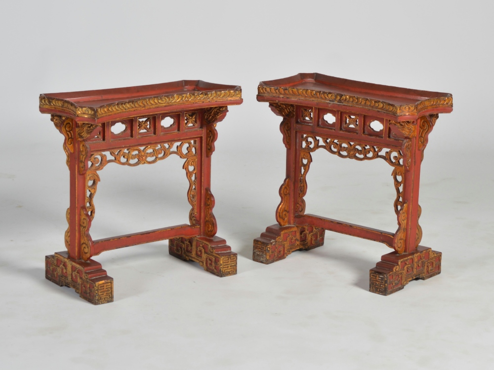 A pair of Chinese red lacquer occasional tables, Qing Dynasty, the shaped rectangular tops on