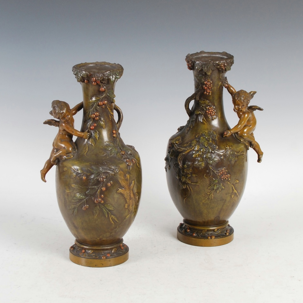 A pair of late 19th century cold painted bronzed spelter vases after F. Moreau, cast with fruiting