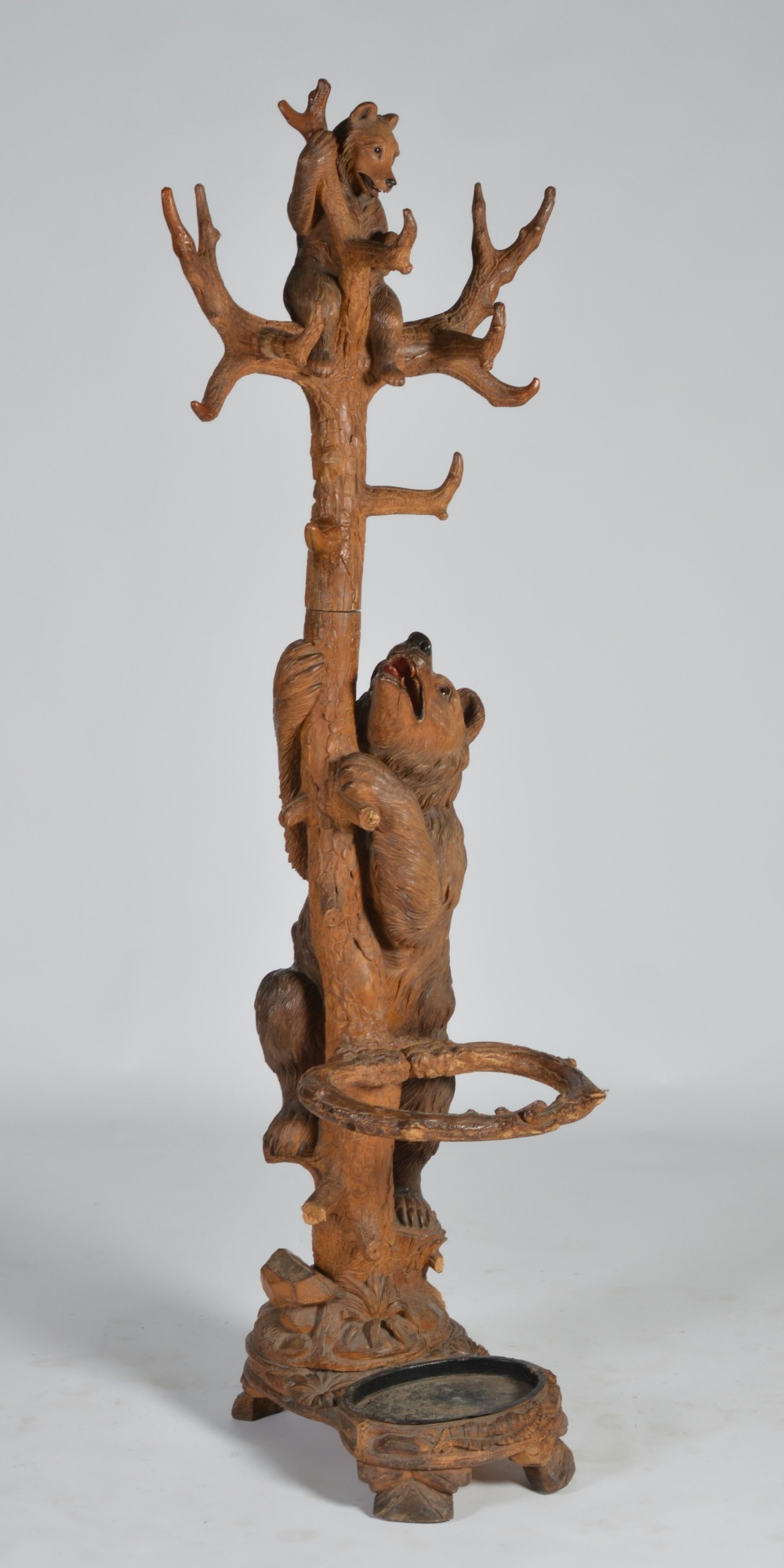 A late 19th century Black Forest carved wood bear and cub hall stand, the bears with glass eyes
