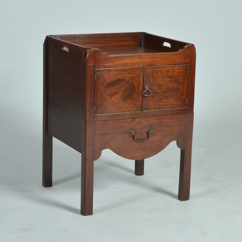 A George III mahogany tray top commode, the rectangular top above a pair of cupboard doors and