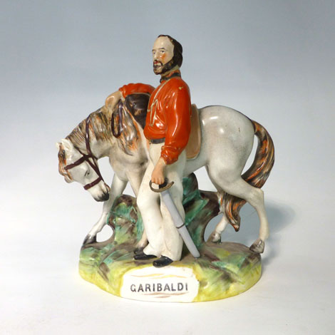 A Staffordshire equestrian figure of Garibaldi standing beside a horse facing left, by Thomas