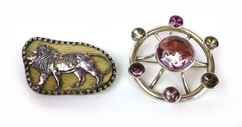 A Scottish silver brooch of circular form set coloured glass, d. 6 cm and an African silver brooch