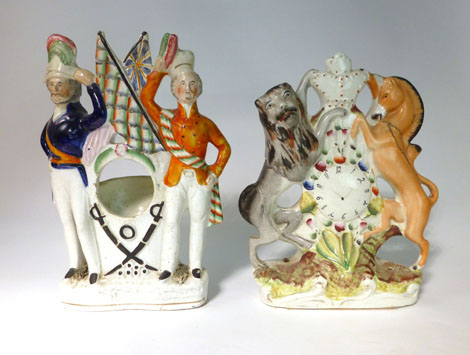 A Staffordshire Crimea clock holder group modelled as two soldiers flanking a pair of crossed