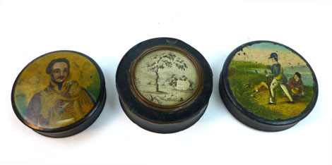 A 19th century circular papier machine snuff box decorated with a shooting scene, another