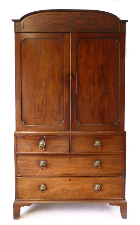 A 19th century mahogany linen press, the arching cornice above a pair of panelled doors, in turn