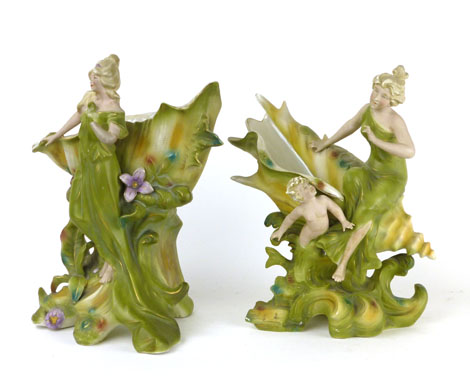 A pair of Continental porcelain Art Nouveau-style vases modelled as maidens and cherubs around