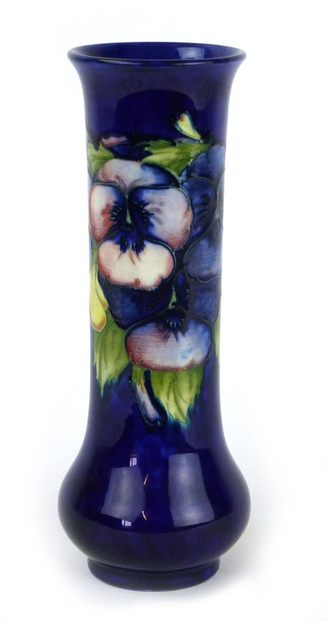 A Moorcroft vase of cylindrical form with bulbous base in the pansy pattern on a blue ground,