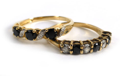 A 9ct yellow gold dress ring set clear and dark blue paste and another yellow metal ring, similar