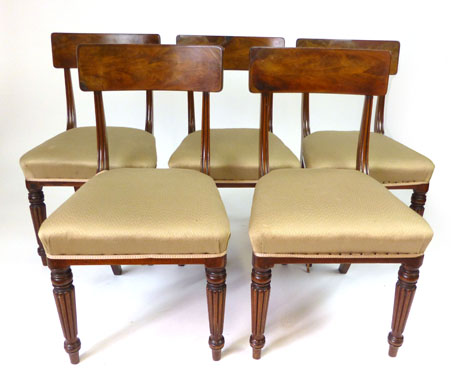 A set of five William IV mahogany dining chairs with broad bar back, stuffed over seats, turned