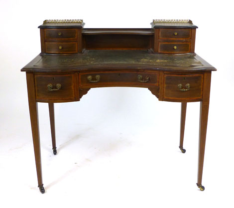 An Edwardian mahogany inverted serpentine lady's writing table, superstructure with two pairs of