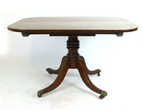 A Victorian mahogany tilt top breakfast table, the rectangular top raised on a turned column and