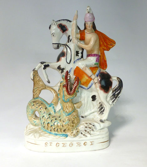 A Staffordshire equestrian figure titled 'St. George', his horse rearing above the dragon, h. 29 cm
