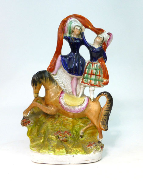 A Staffordshire equestrian circus group modelled as a pair of dancers standing on the back of a
