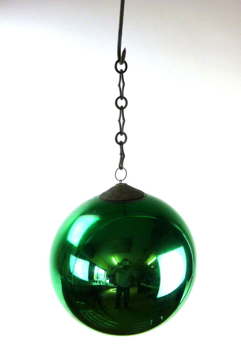 A green glass witches ball, d. 25 cm   CONDITION REPORT:  silvering 'flaky'