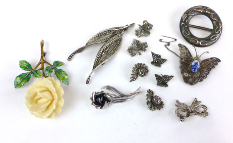 A small group of marcasite set jewellery, two filigree work brooches, a wreath brooch and a