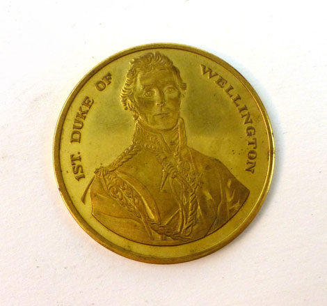 A gilt metal medal comemmorating the life of the First Duke of Wellington, the reverse with a