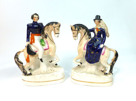 A pair of Staffordshire equestrian figures modelled as Queen Victoria and Prince Albert, h. 21 cm