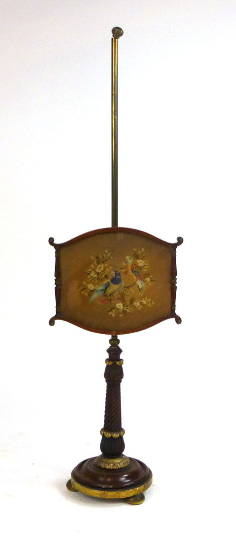 A 19th century rosewood and gilt gesso and brass pole screen, the base with foliate and wrythen
