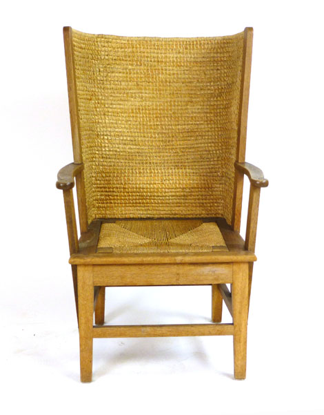 An Orkney chair with an oak frame, woven rush back and seagrass seat   CONDITION REPORT:  some water