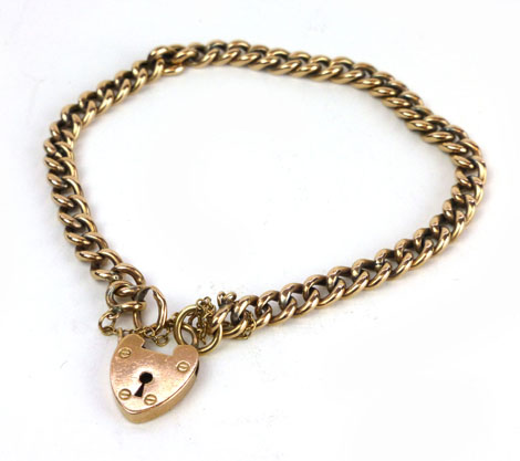 A 9ct yellow gold curb link bracelet with padlock catch, approx. 8.5 gms