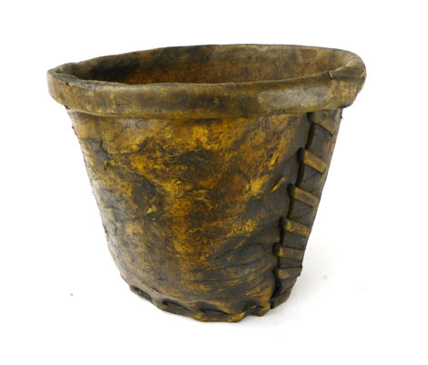 An animal skin log basket/bucket of tapering circular form with crudely stitched seams, d. 44 cm