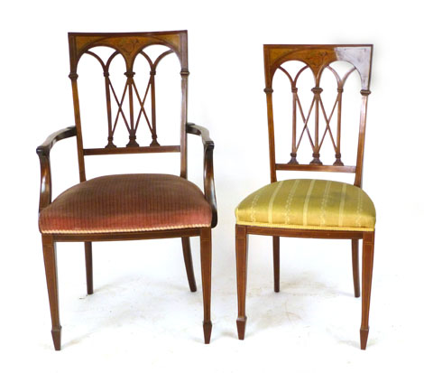 An Edwardian mahogany inlaid elbow chair, the rectangular back with arching fret work and inlaid