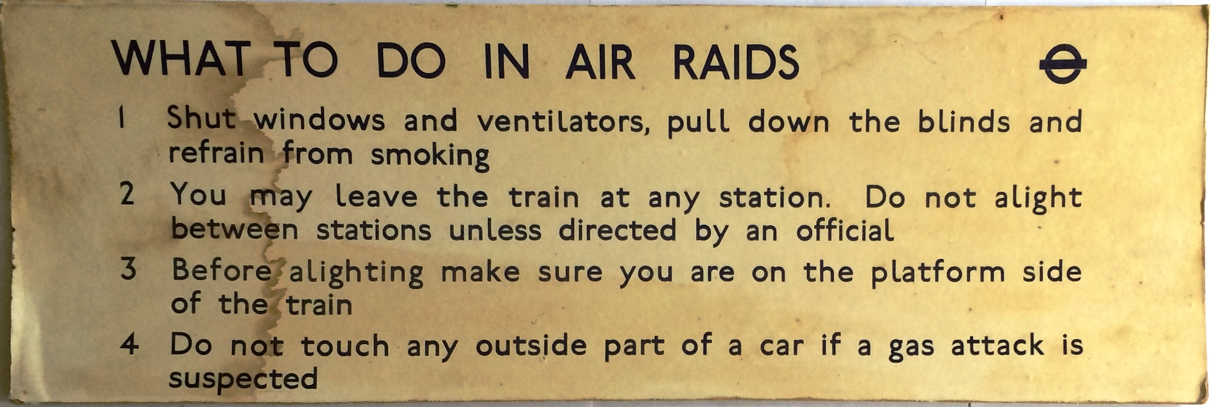 WW2 London Underground CAR NOTICE 'What to do in Air Raids'. Paper on a hardboard backing and