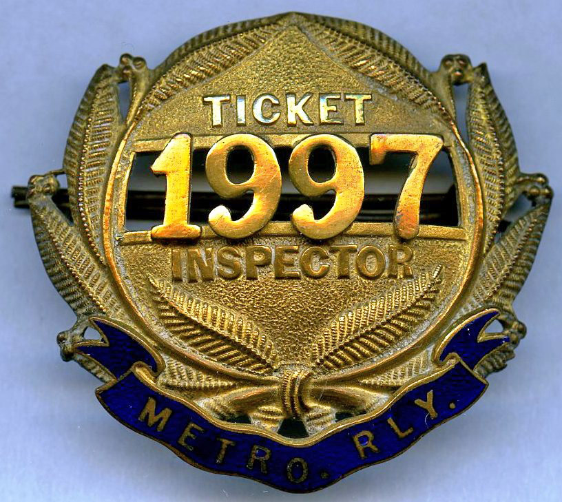 Metropolitan Railway TICKET INSPECTOR'S CAP BADGE with serial number 1997. Made of brass with inlaid