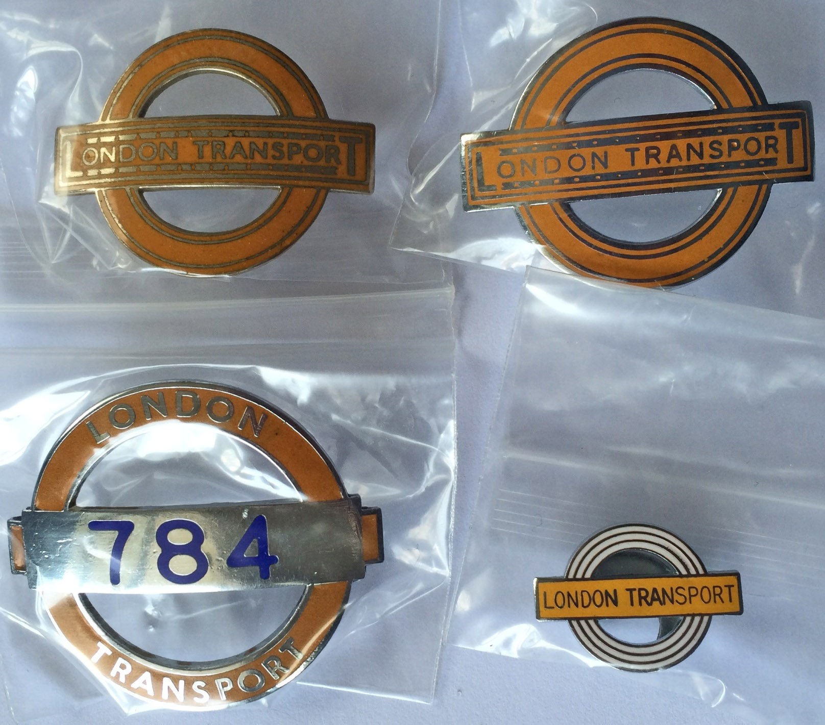 London Transport Underground enamel CAP & LAPEL BADGES comprising a numbered type issued to guards