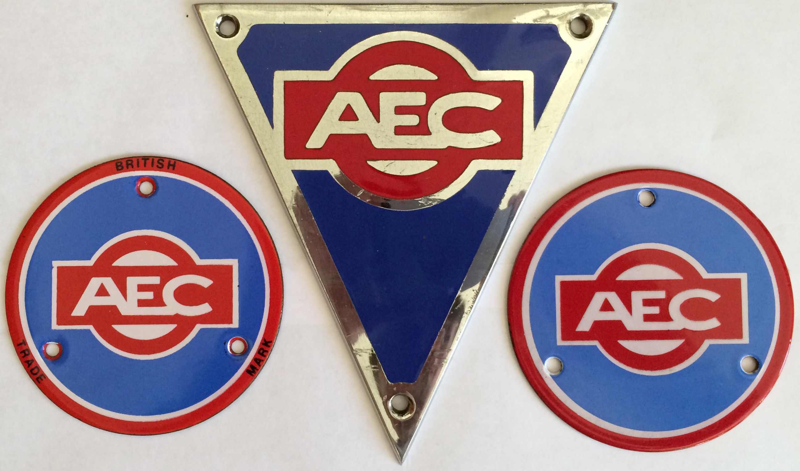 Set of AEC VEHICLE BADGES comprising an enamel & chrome RADIATOR TRIANGLE and two enamel HUB BADGES.