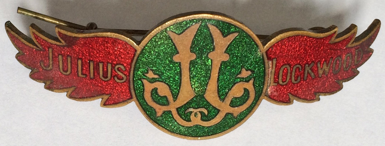 An enamelled CAP BADGE 'Julius Lockwood', complete with fixing pin. It has not been possible to find