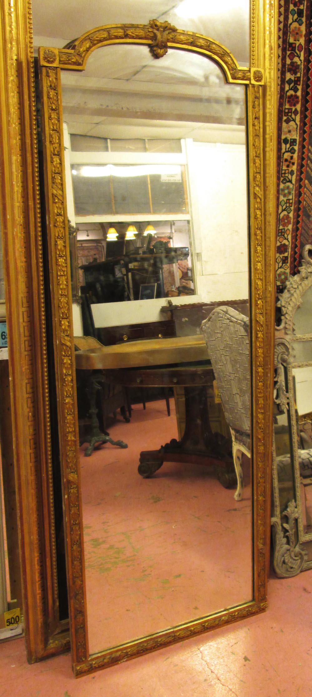 PIER MIRROR, Victorian gilt with an arched top and a laurel leaf and berry decorated surround,