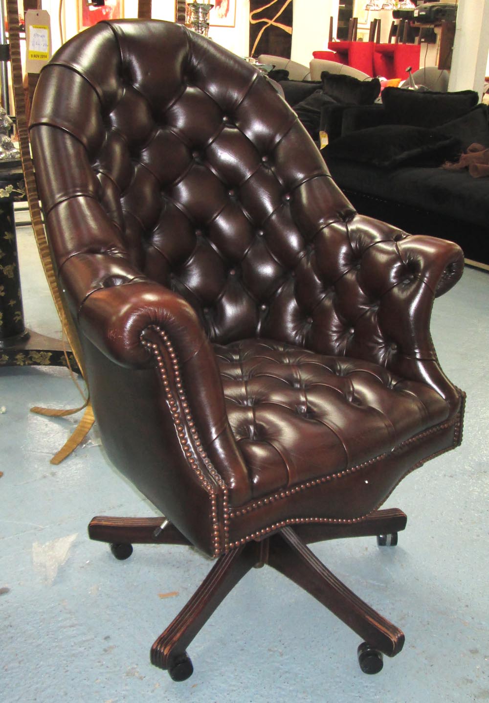 DESK CHAIR, buttoned brown leather upholstered with swivel seat, 80cm W. (with faults)