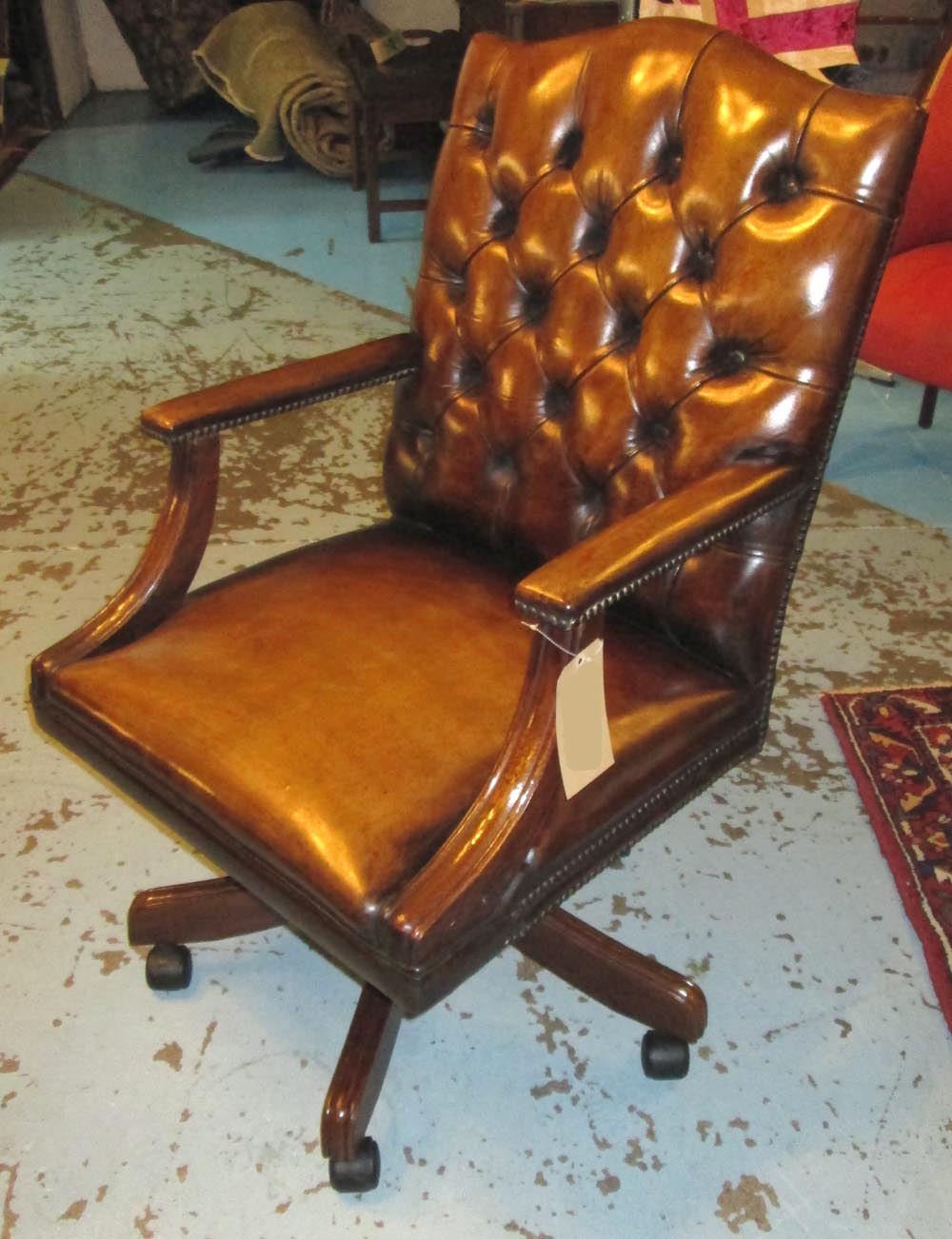 REVOLVING DESK CHAIR, square back captain chair upholstered in deep button faded tan brown leather