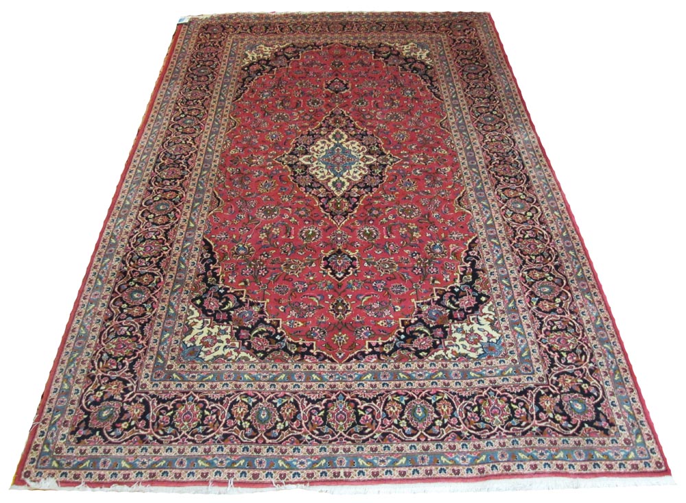 FINE KASHAN CARPET, 300cm x 195cm, the ivory and sapphire medallion on ruby field with scrolling