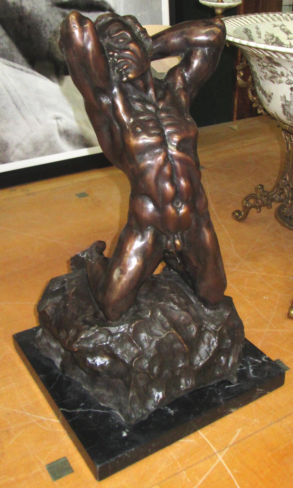 AFTER ALFREDO PINA, 'Man on a rock', bronze, 51cm H.