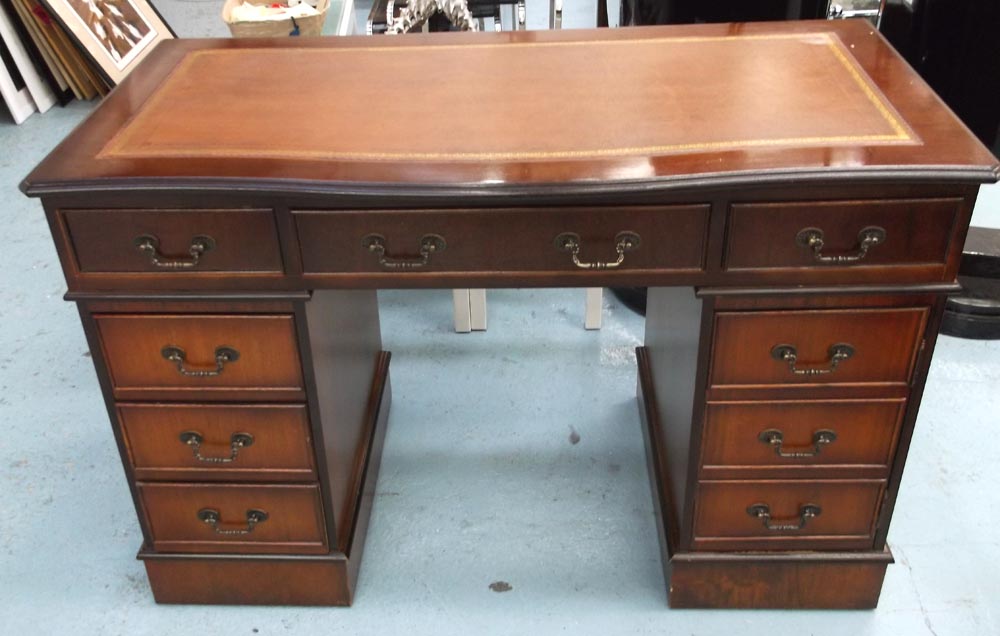 PEDESTAL DESK, mahogany with a serpentine front, 121cm x 79cm H x 63cm D.