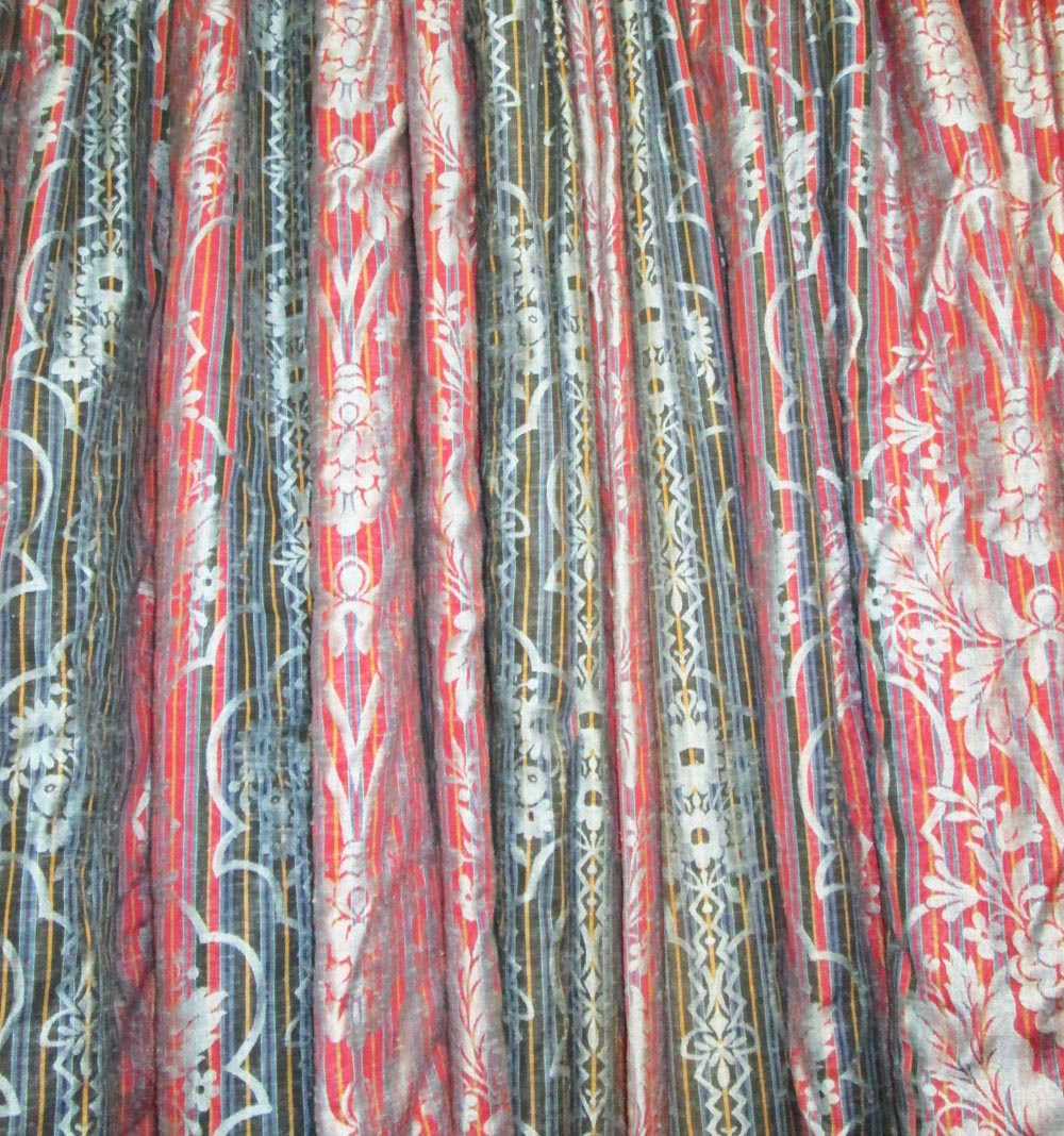 CURTAINS, a pair, in a red and blue patterned fabric with flowers and stripes, each 130cm W gathered