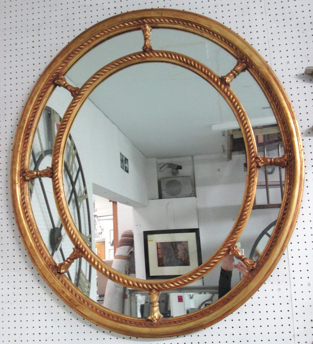 MIRROR, in an oval shape with a gilt frame and a section border having twisted rope decorations,