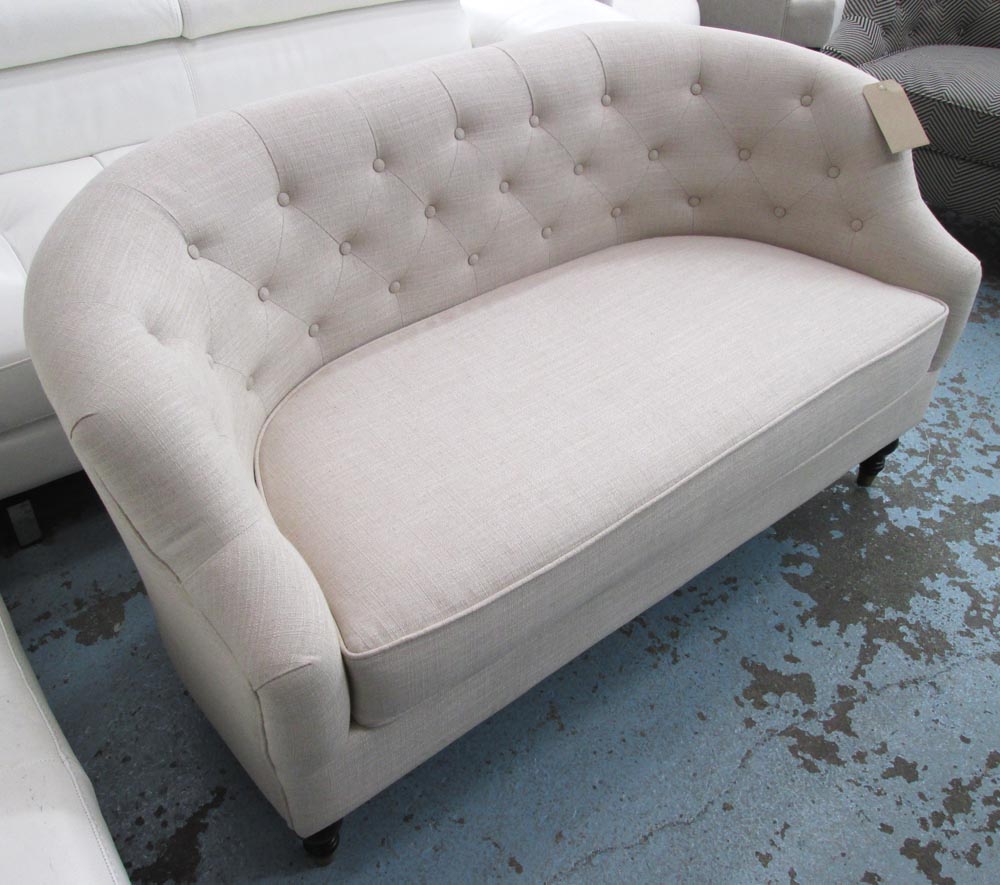 SOFA, two seater, with a buttoned, curved back and oatmeal upholstery, 140cm L.