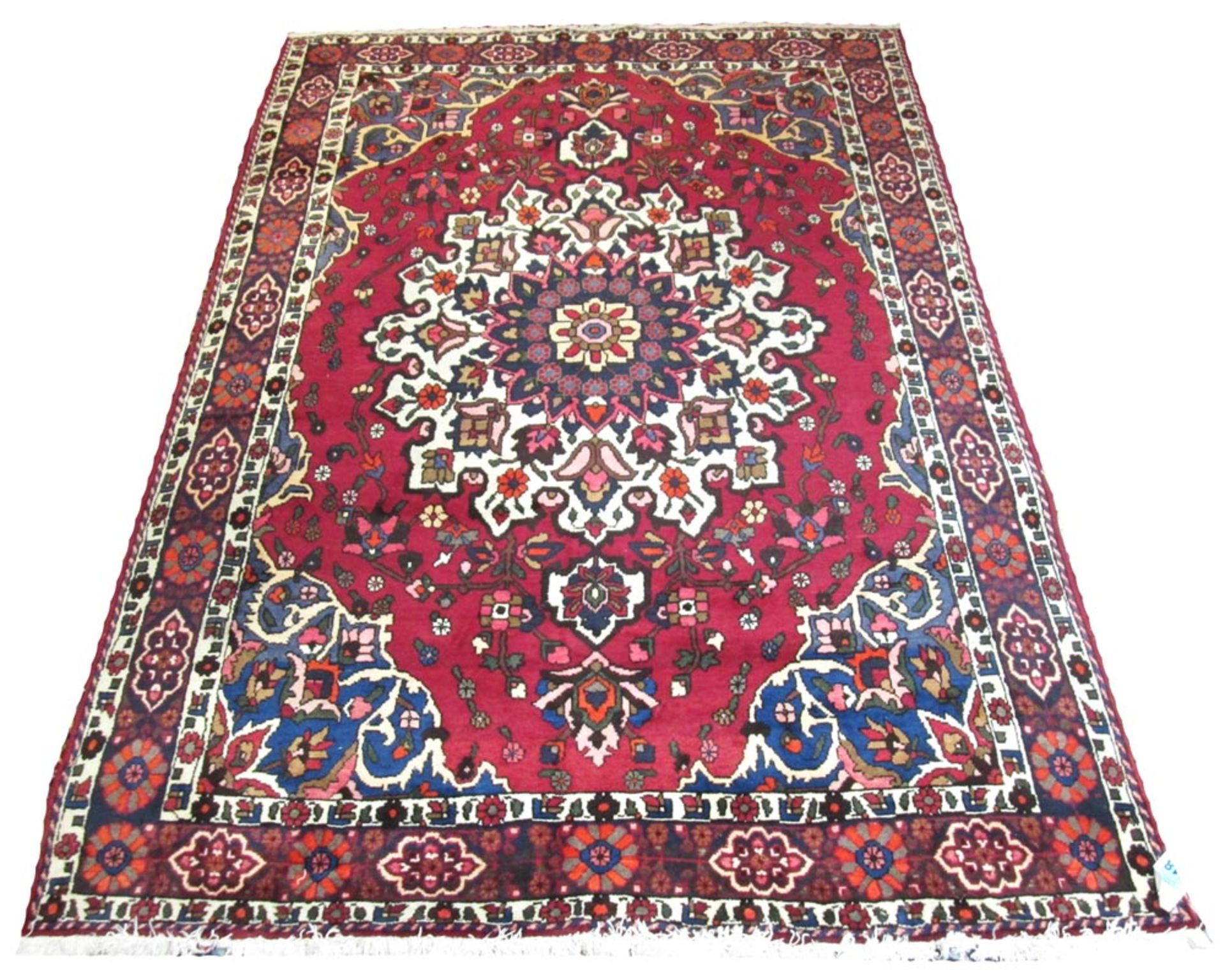 BAKHTIARI CARPET, 311cm x 205cm, sapphire and ivory rosette medallion on ruby field.