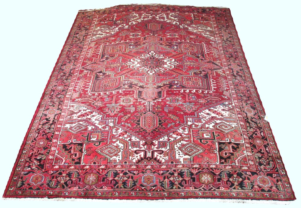 HERIZ CARPET, 360cm x 265cm, central medallion on ruby field of stylised palmettes within