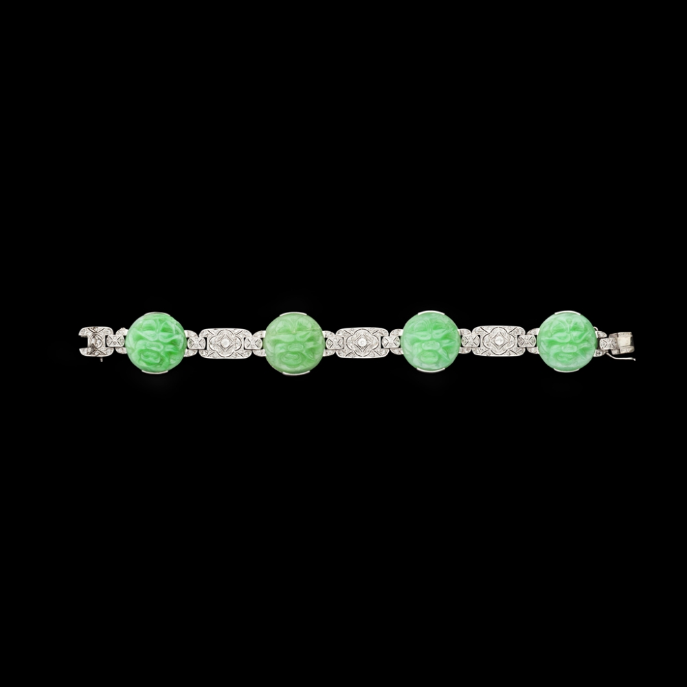 An Art Deco jade and diamond set braceletcomposed of four foliate carved circular jade panels, - Image 2 of 2