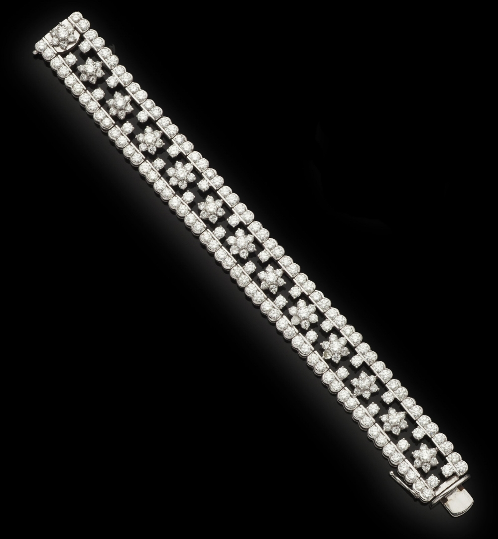 A platinum mounted diamond set braceletof articulated design set throughout with round brilliant
