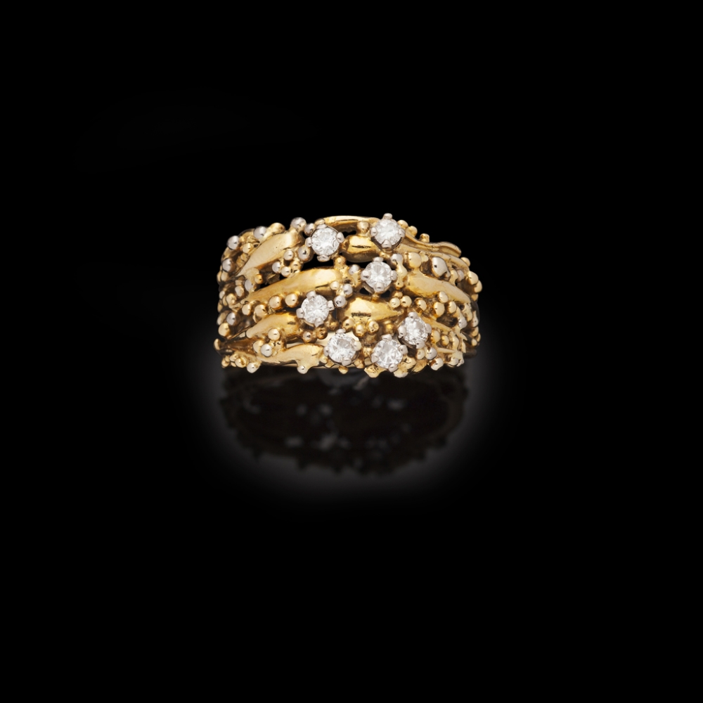 CHARLES DE TEMPLE - A modern diamond set ringmodelled as a broad textured band in 18ct gold with