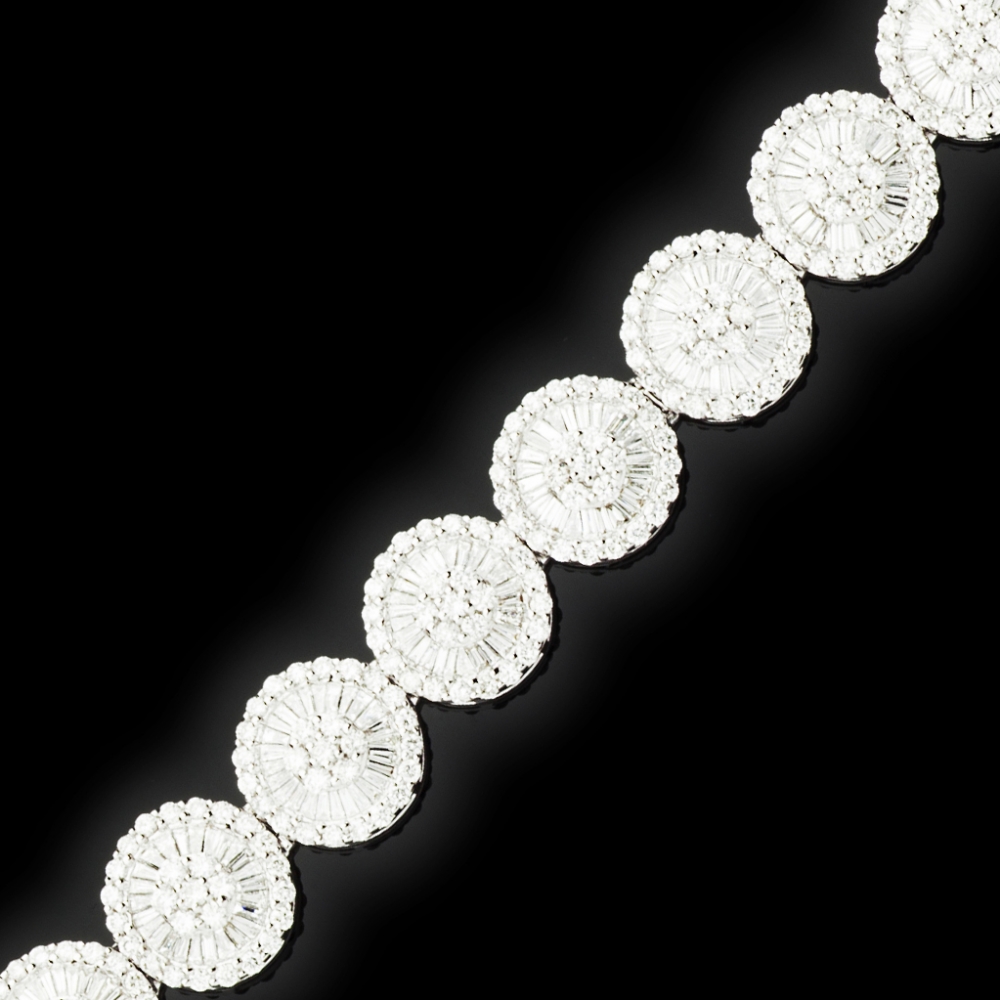 A contemporary diamond braceletcomposed of fourteen circular clusters, each set in white metal with