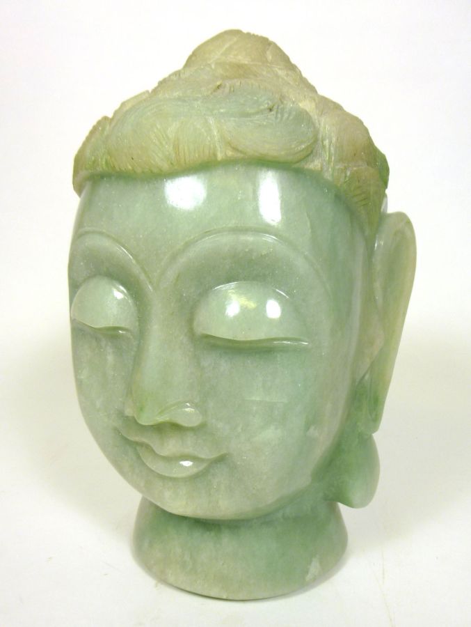 LARGE CHINESE GREEN QUARTZ HEAD OF BUDDHAwith carved features and elongated lobes31cm high