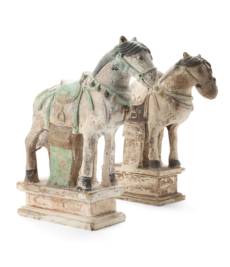 TWO CHINESE PAINTED POTTERY HORSE FIGURESPROBABLY MING DYNASTYthe saddled animals standing four