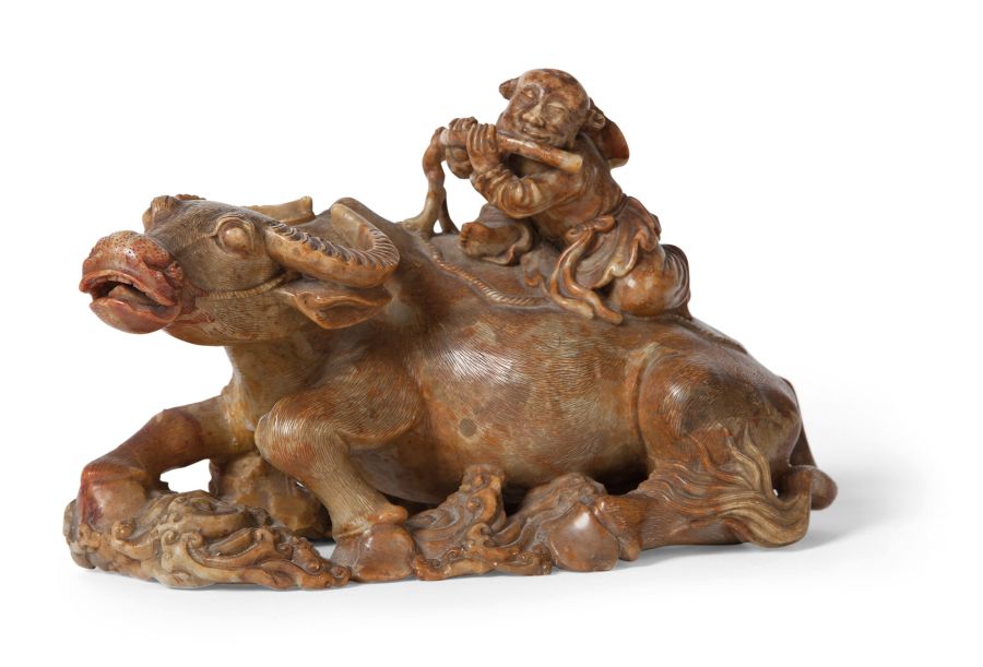 HARDSTONE FIGURE OF A WATER BUFFALOthe recumbent figure with a boy seated on its back and playing a