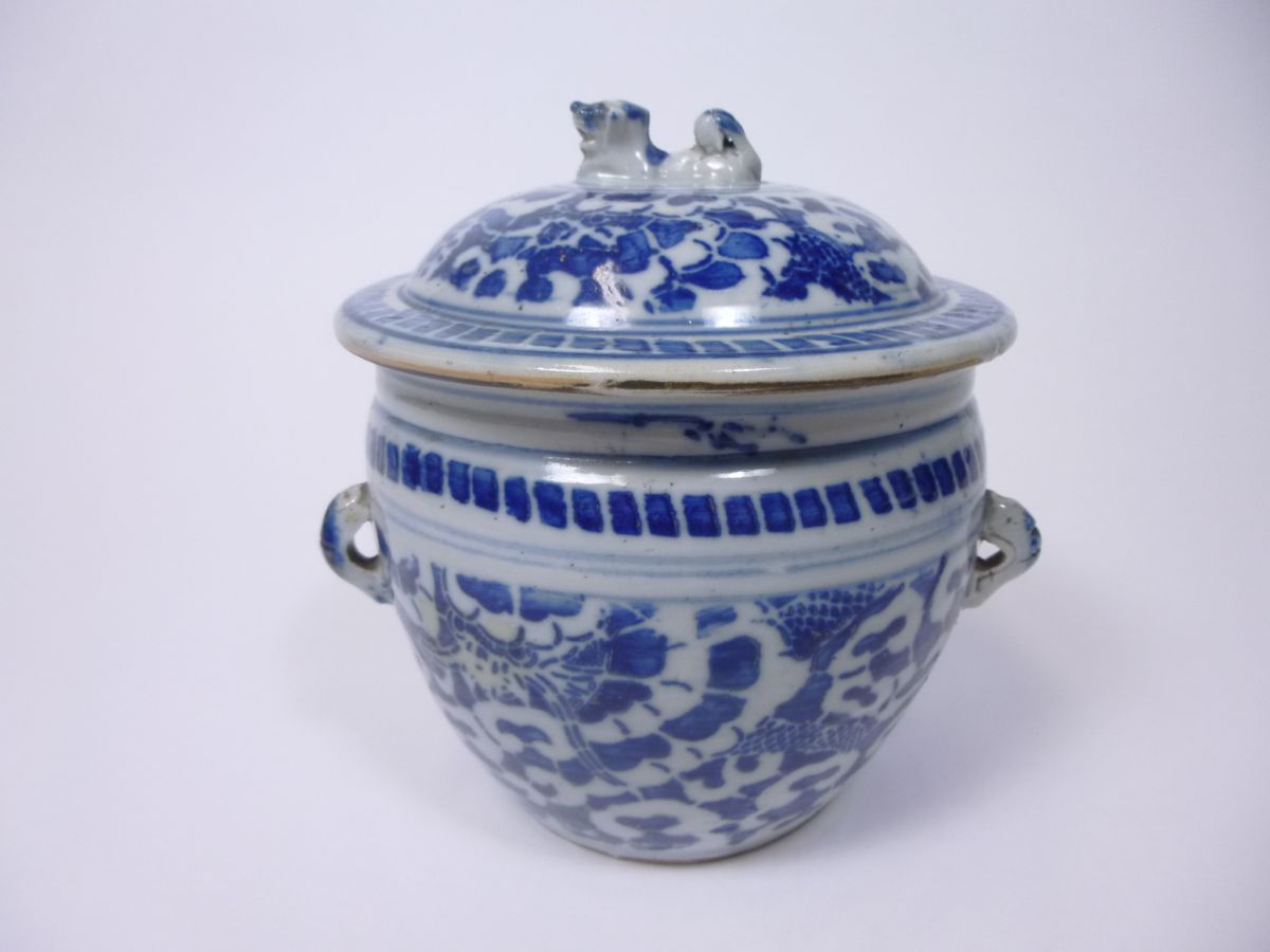 CHINESE PROVINCIAL BLUE AND WHITE COVERED JARQING DYNASTYof ovoid form with looped handles and a